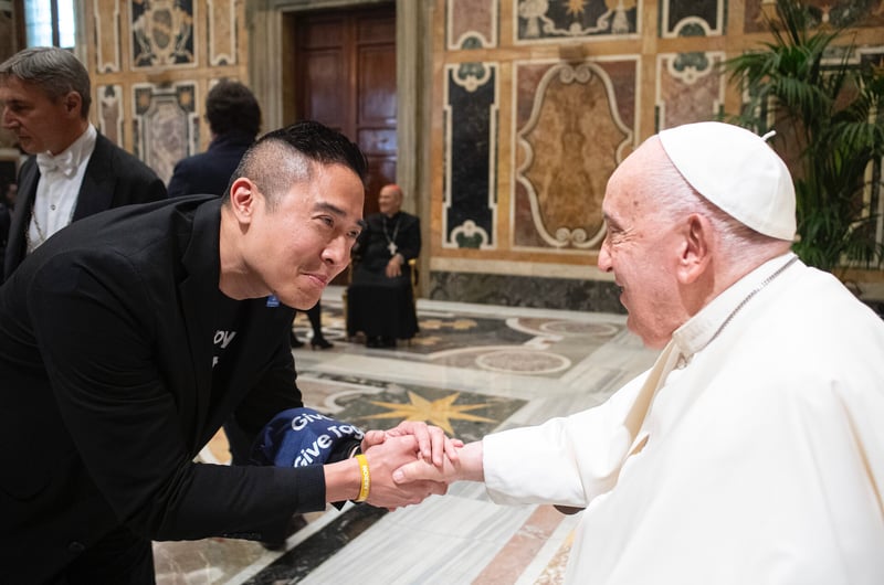 GivePulse CEO, George Luc, shaking hands with Pope Francis at the Vatican. 