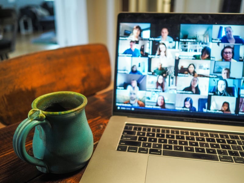 Virtual webinar attendee showing an image of a virtual webinar meeting on their laptop