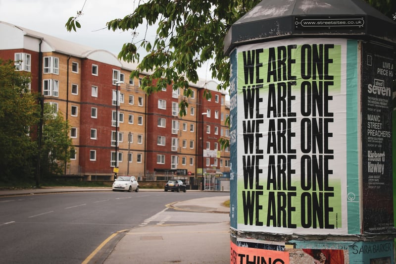 "We are one" posters on a bulletin board