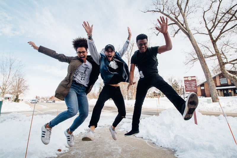 Three college students jumping for joy!